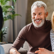 Couple smiling at therapist in session